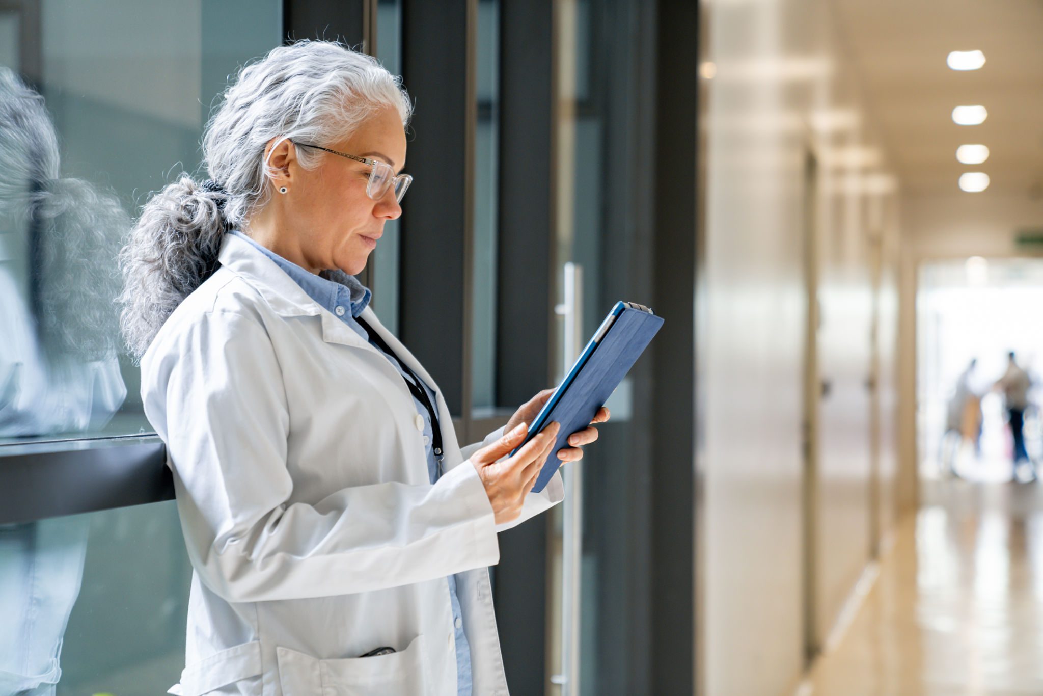 Medical professional reading on digital device